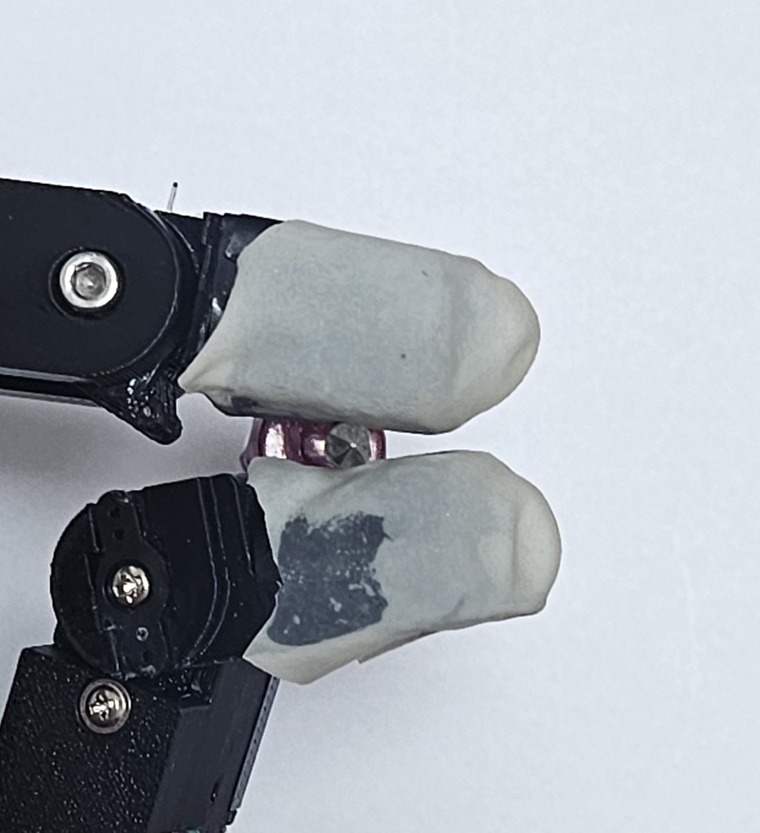Index and thumb fingertips pinching a small screwdriver
