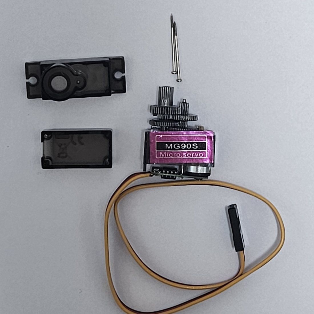 A stock MG90S micro servo taken apart